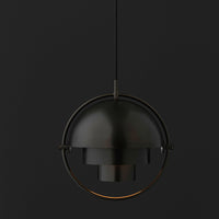 Black and gold pendant lamp with a sleek, modern design against a dark background. Elegant and minimalist aesthetic.