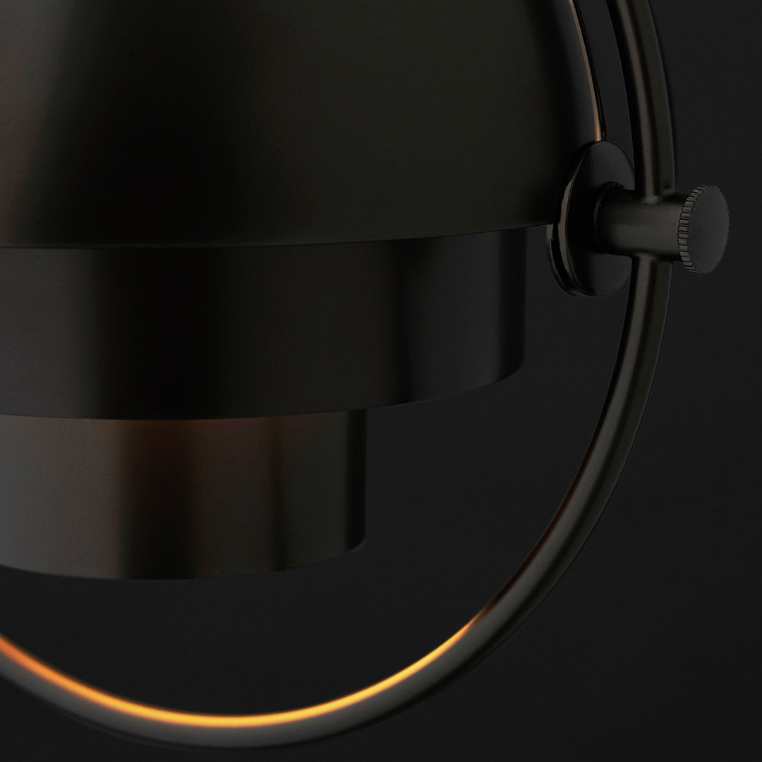 Black metal lamp with a sleek, modern design and warm glowing ring accent. Perfect for contemporary home decor.
