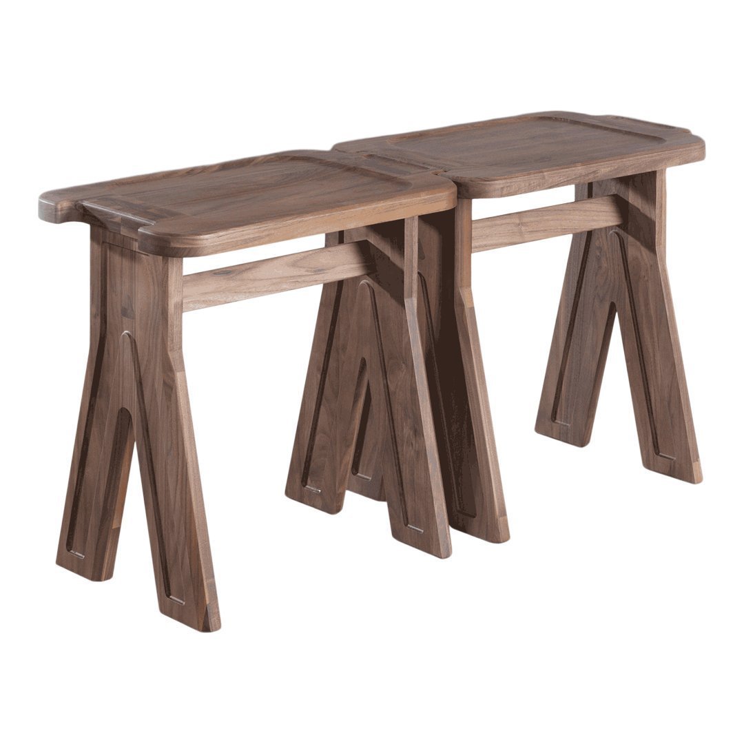 Two rustic brown wooden stools with a smooth finish and angular, stable legs, showcasing a natural wood grain pattern.