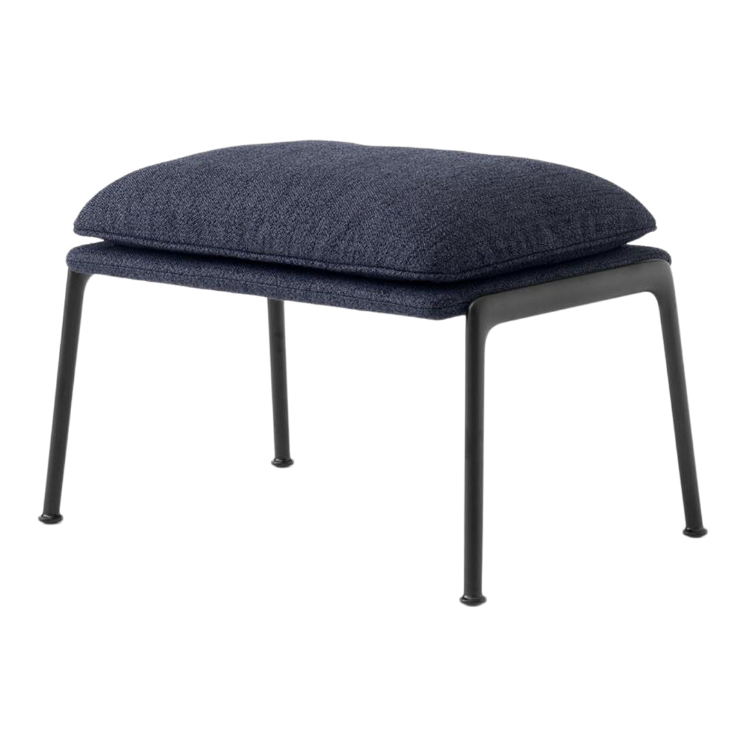 Navy blue cushioned ottoman with a textured fabric seat and sleek black metal legs. Ideal for modern decor.