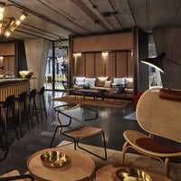 Stylish lounge area featuring earthy tones, sleek wood accents, and modern metallic elements in a contemporary design.