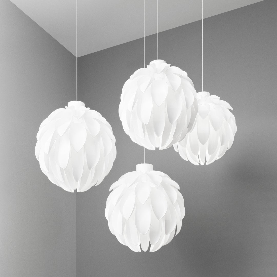 Four textured white pendant lamps with a leaf-like pattern, hanging against a soft gray wall.