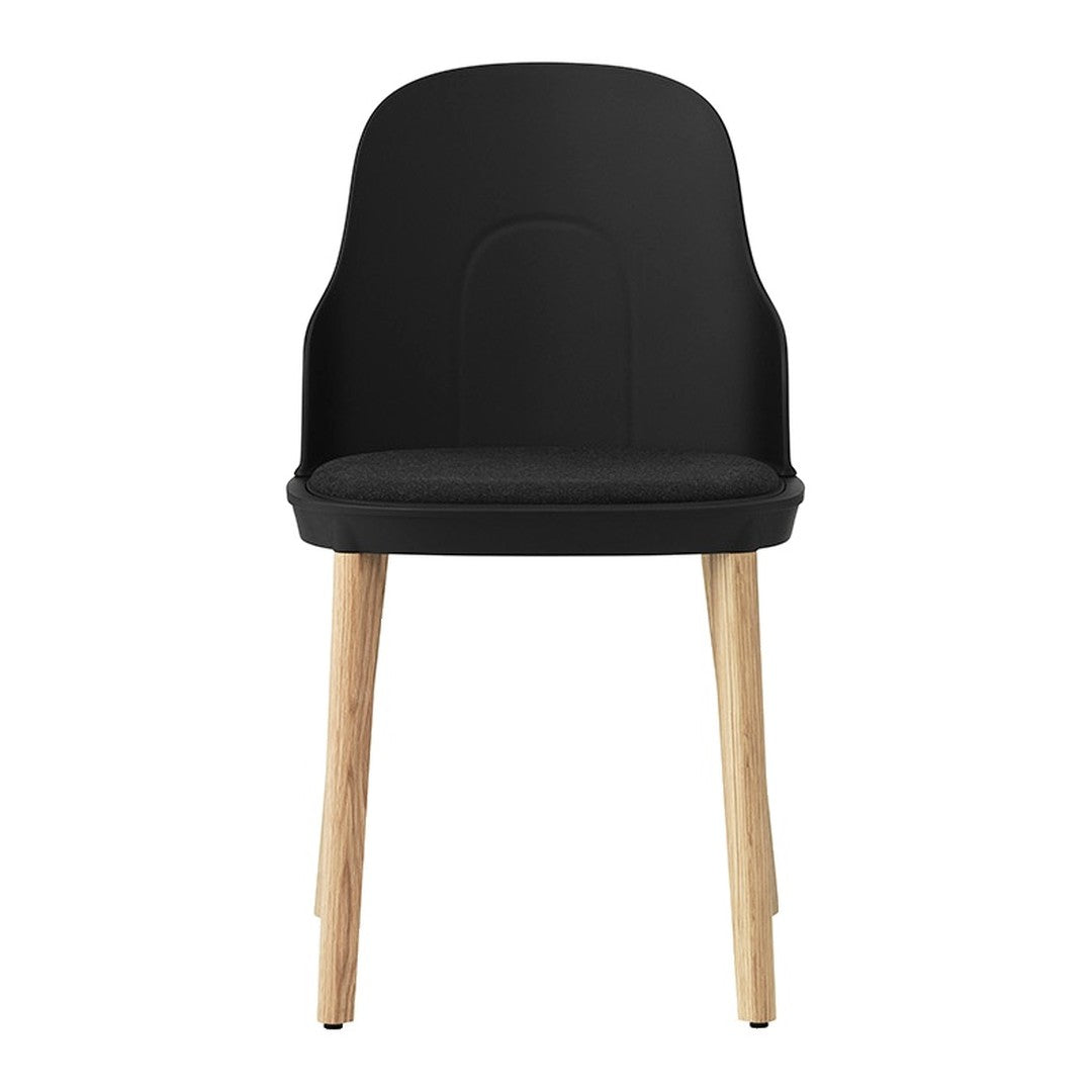 Black chair with a smooth finish and natural wood legs, featuring a minimalist design. Perfect for modern decor.