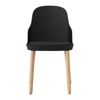 Black chair with a smooth finish and natural wood legs, featuring a minimalist design. Perfect for modern decor.