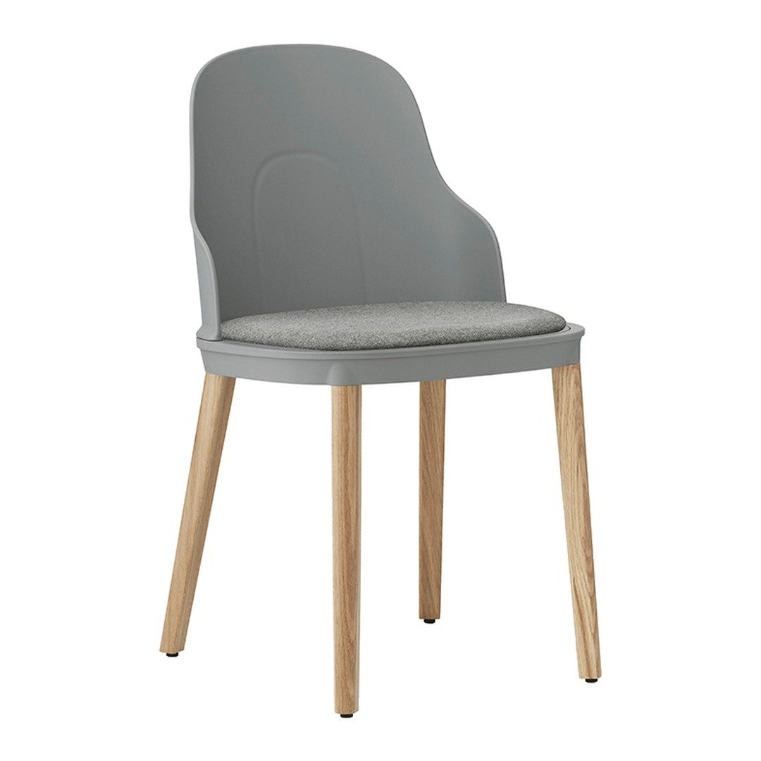 Light gray chair with a smooth finish and soft gray cushion, complemented by natural wood legs. Stylish and modern design.