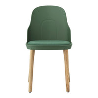 Green plastic chair with smooth surface and light wood legs, offering a modern and stylish design.