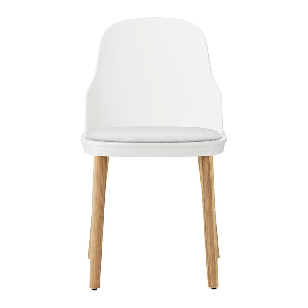 White chair with wooden legs and a simple, modern design, featuring a smooth finish and minimalistic style.