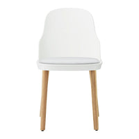 White chair with wooden legs and a simple, modern design, featuring a smooth finish and minimalistic style.