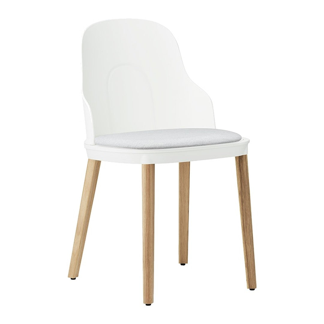 White chair with a sleek design and light gray cushioned seat, featuring natural wood legs.
