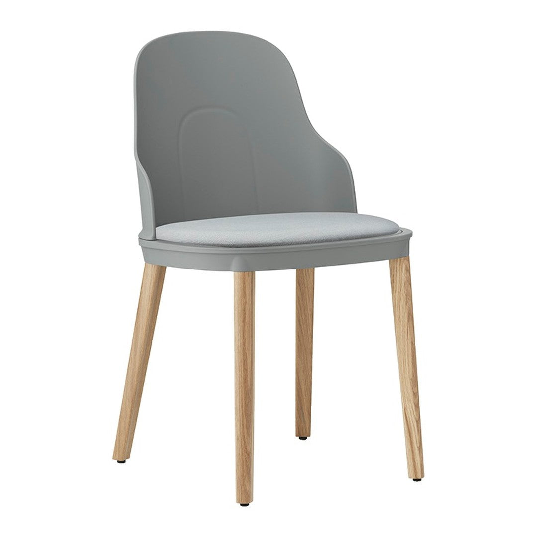 Gray plastic chair with a soft white seat and light wooden legs, featuring a smooth, modern design.