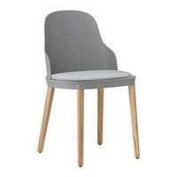 Gray plastic chair with a soft white seat and light wooden legs, featuring a smooth, modern design.
