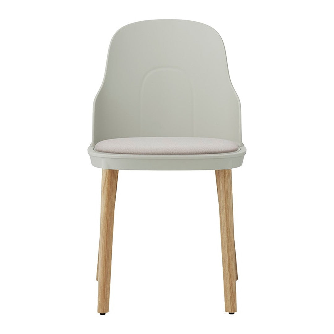 Light gray chair with a soft pink seat cushion and natural wood legs. Minimalist design for modern spaces.