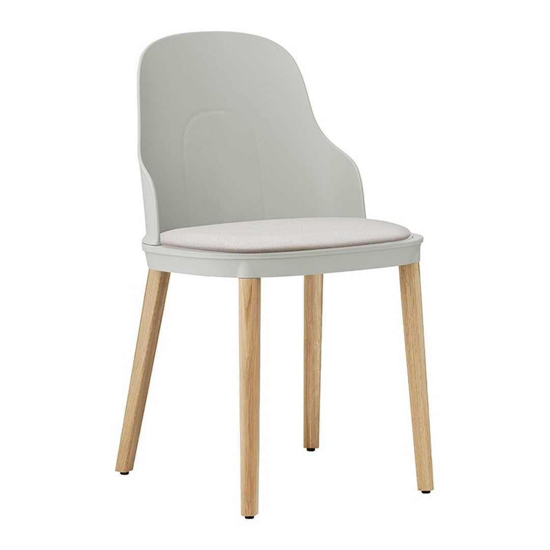 Soft gray chair with a smooth, curved back and light wooden legs, featuring a simple, minimalist design.