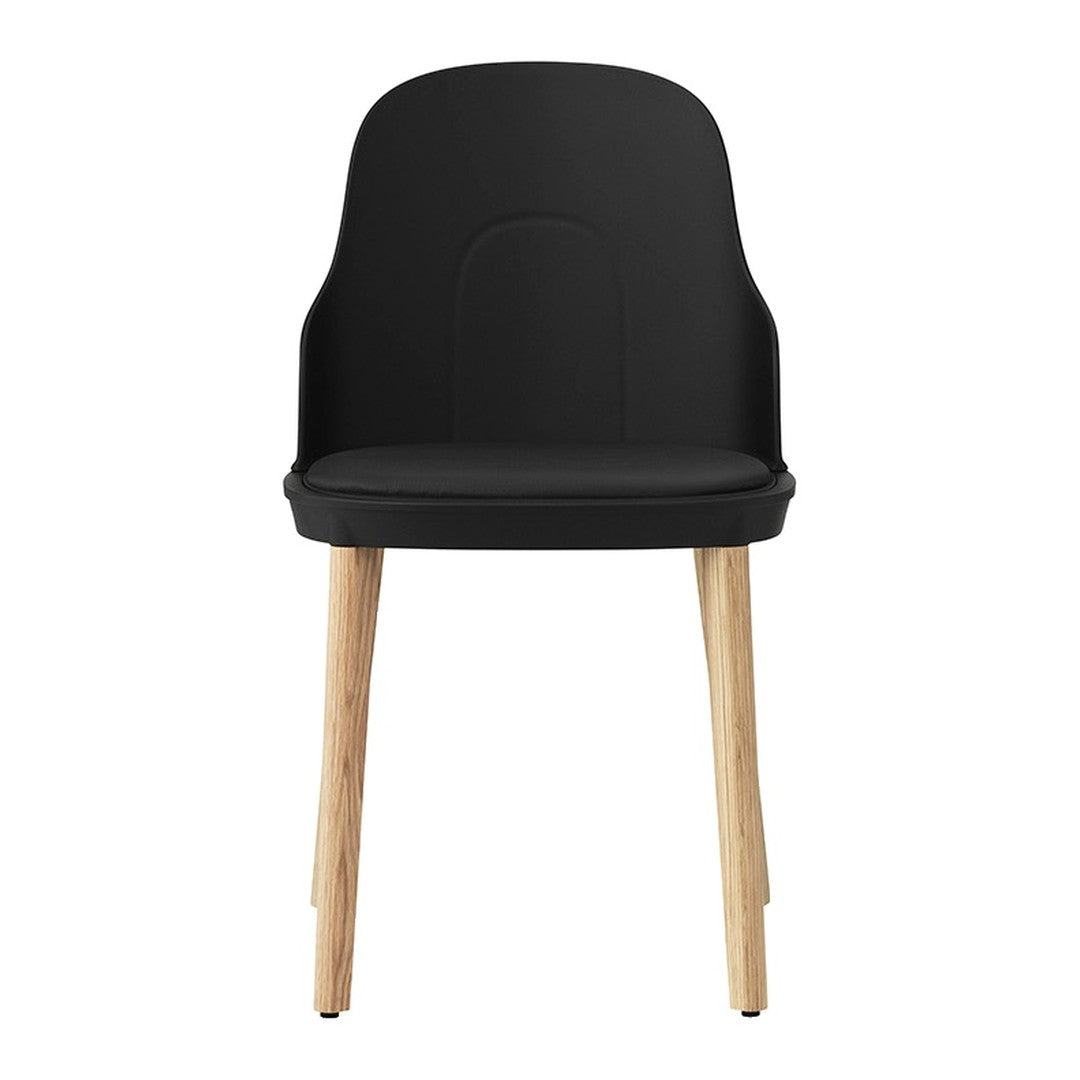 Black ergonomic chair with natural wooden legs, featuring a sleek, minimalist design.