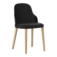 Black chair with smooth upholstery and natural wood legs for a modern, stylish look. Ideal for contemporary settings.