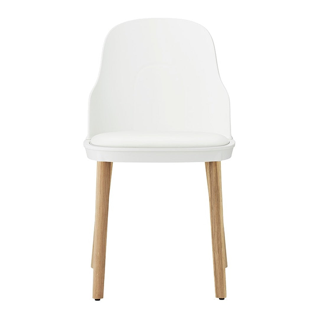 White modern chair with smooth plastic finish and natural wood legs. Sleek, minimalist design for any decor.