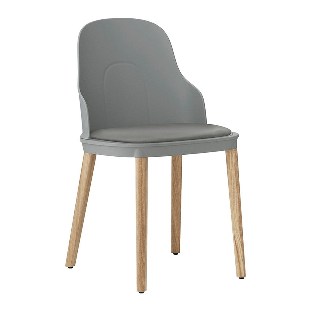 Gray plastic chair with a smooth finish and natural wood legs, featuring a minimalist design.