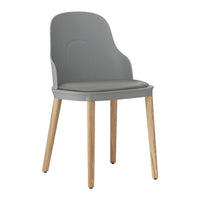 Gray plastic chair with a smooth finish and natural wood legs, featuring a minimalist design.