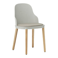 Light gray chair with a smooth, curved back and beige cushioned seat on natural wooden legs.