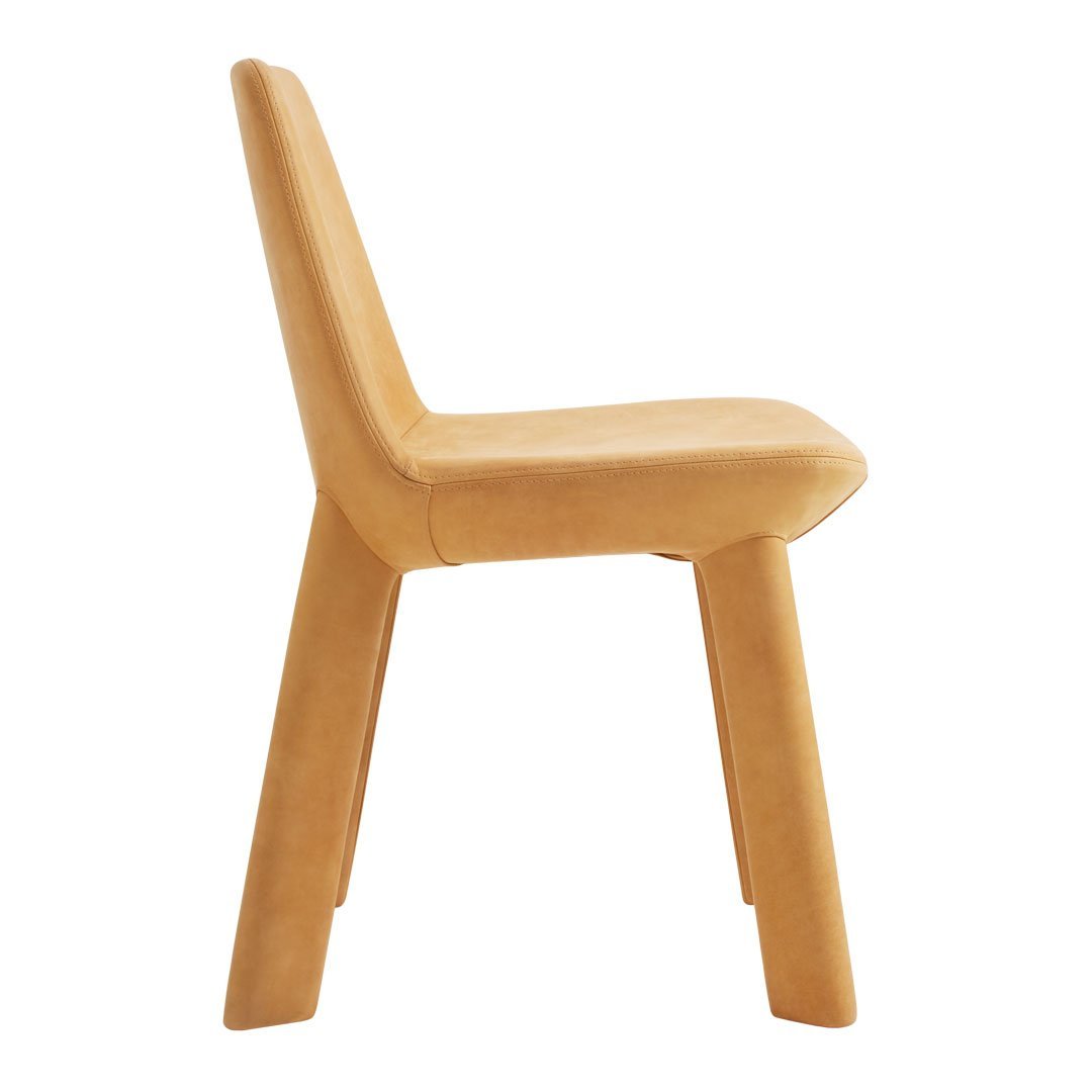 Side view of a minimalistic chair in warm mustard yellow with a smooth, clean surface and geometric design.