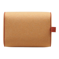 Orange cork pillow with contrasting red stitching and handle, offering a modern, minimalist design.
