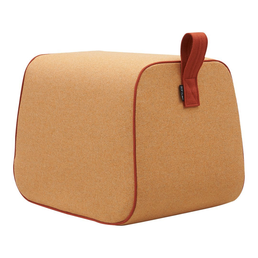 Stylish tan square ottoman with a textured finish and deep red piping for a chic accent.