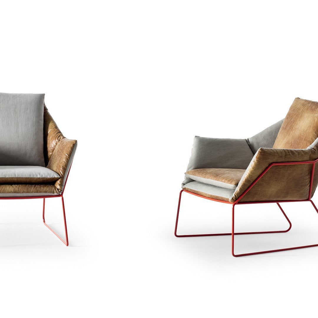 Modern chair featuring a mix of soft gray and rich brown upholstery with a striking red metal frame.