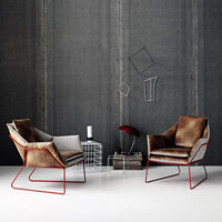 Two modern armchairs in a mix of soft gray and warm brown textures, featuring sleek red metal frames.