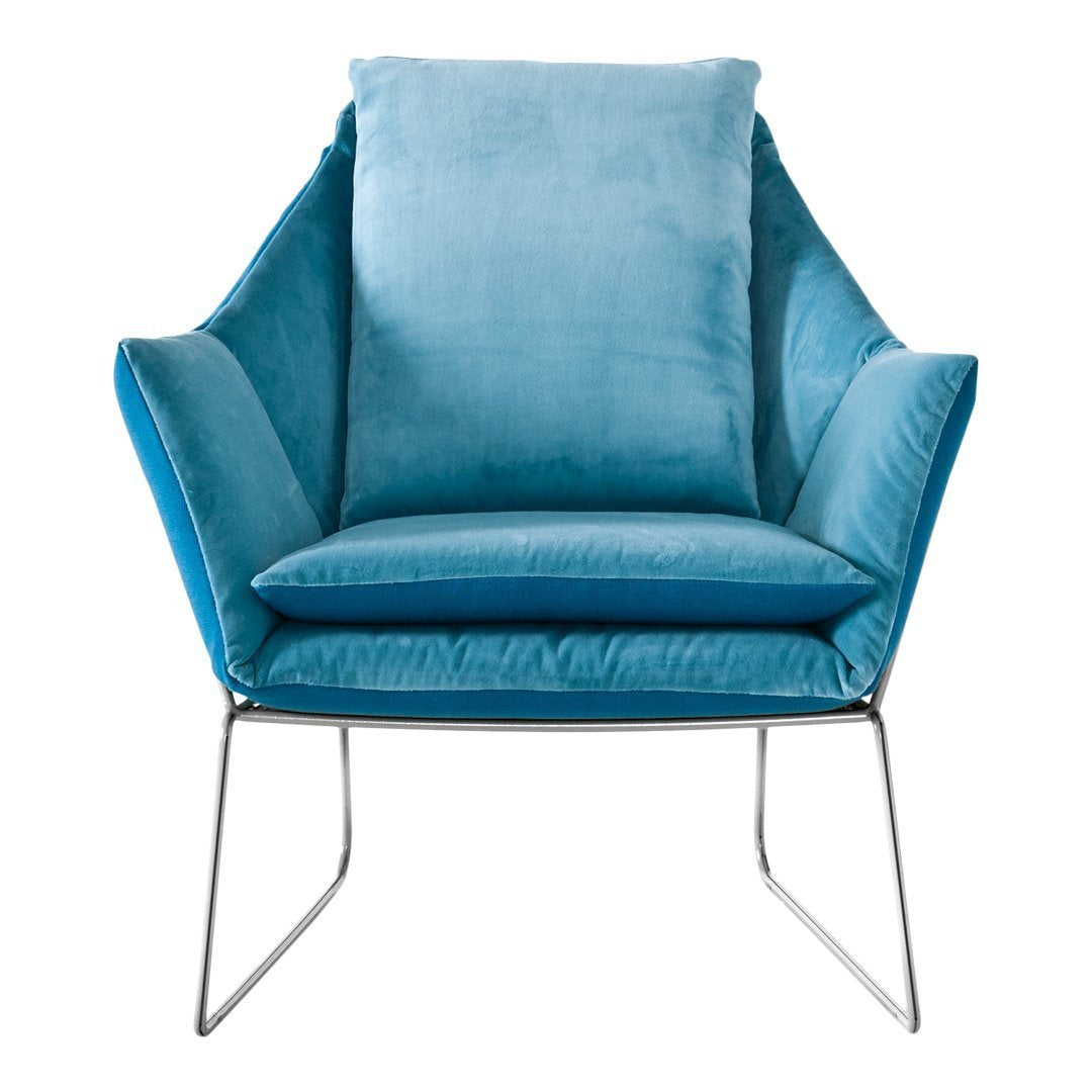 Modern chair in soft teal velvet with sleek silver legs, featuring smooth, contoured shapes and plush cushioning.