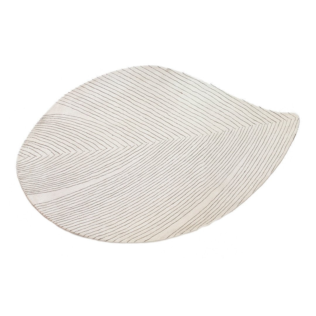 White leaf-shaped platter with subtle textured lines, adding elegance to any table setting.