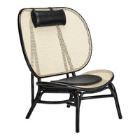 Black and cream woven rattan chair with a sleek design and contrasting leather headrest. Elegant mid-century style.
