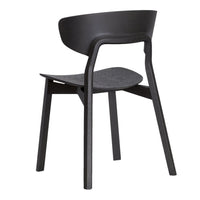 Black wooden chair with a smooth, minimalist design and curved backrest, showcasing a contemporary aesthetic.