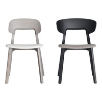 "Set of two minimalist chairs: one in light gray and one in sleek black, featuring smooth, simple lines."