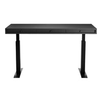 Sleek black desk with a minimalist design and smooth, matte finish, featuring clean lines and subtle drawer accents.