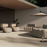 Beige modern outdoor seating set with rounded shapes and smooth textures, against a neutral background.