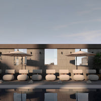 Neutral beige loungers with gray concrete walls and soft sky-blue accents, paired with light umbrellas and greenery.