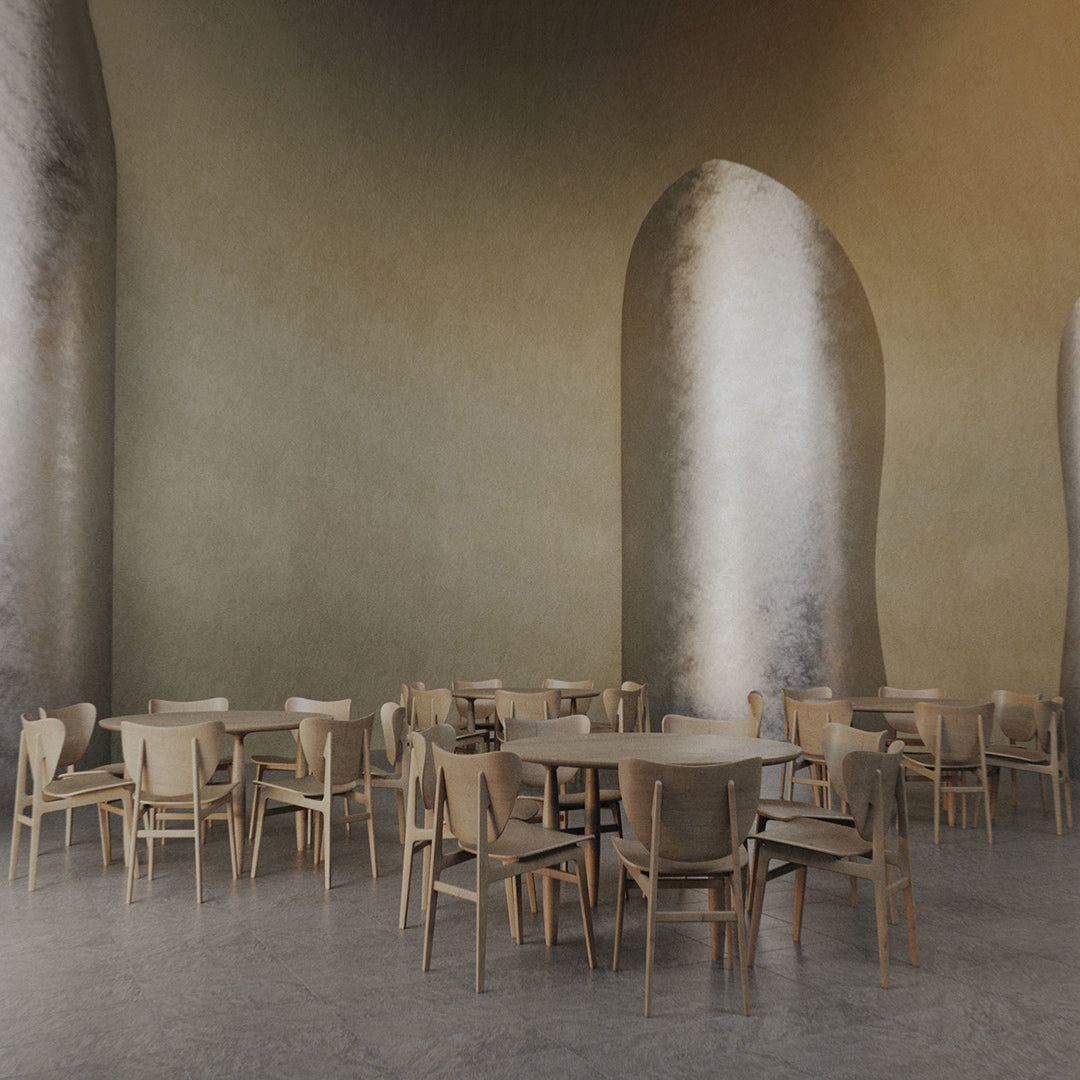 Neutral beige walls and silver arches complement light wood furniture, creating a modern, minimalist dining space.
