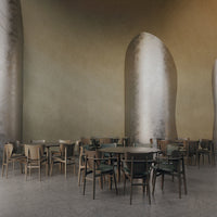 Modern dining area featuring earthy tones, sleek metal accents, and minimalist wooden furniture with green upholstery.