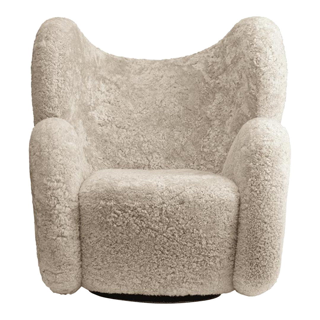 Light beige accent chair with textured, plush fabric and rounded arms, featuring a cozy and modern design.