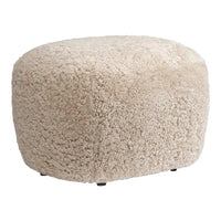 Cream-colored faux fur pouffe with a soft, textured surface, perfect for adding warmth to any space.