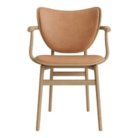 Tan leather chair with smooth texture and minimalist wooden frame in light beige. Stylish and modern design.