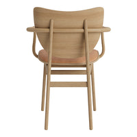 Natural wood chair with a light beige seat and minimalist design, showcasing smooth lines and organic patterns.