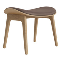 Stylish wood stool with curved design and a soft brown cushioned seat. Ideal for modern interiors.
