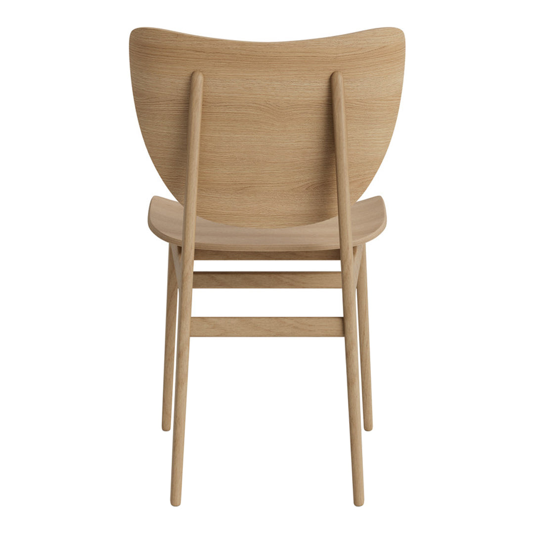 Natural wood chair in light oak finish with a smooth, curved back design. Simple, modern aesthetic.