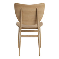 Natural wood chair in light oak finish with a smooth, curved back design. Simple, modern aesthetic.