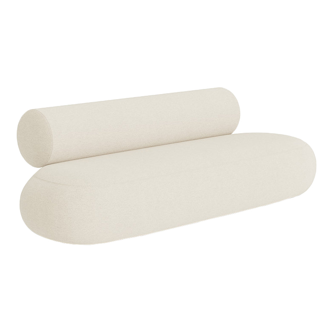 Cream-colored modern sofa with smooth, minimalist curves and a cylindrical bolster cushion. Ideal for contemporary decor.