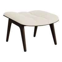 Cream tufted upholstery with dark wood legs, featuring a minimalist design and smooth curves. Perfect for modern décor.