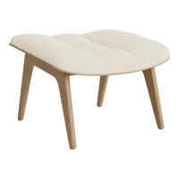 Beige tufted ottoman with smooth wooden legs, featuring a minimalist design and soft texture. Perfect for modern decor.