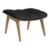 Black tufted fabric ottoman with light wood legs, featuring a modern minimalistic design. Perfect accent for any room.