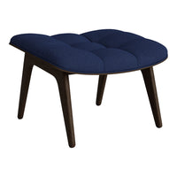 Navy blue tufted upholstery on a modern stool with dark wood legs, perfect for stylish home decor.